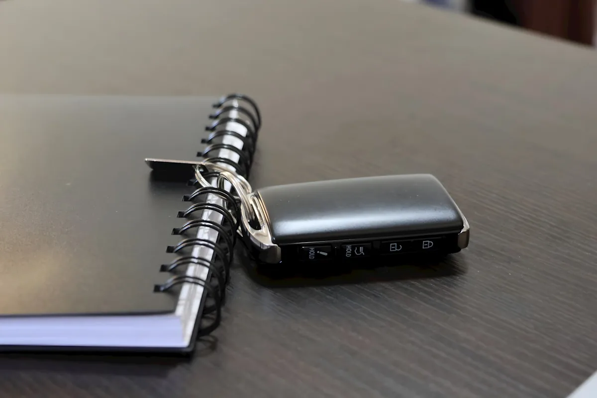 Car key fob resting on a notebook of Nashville SR-22 auto insurance notes