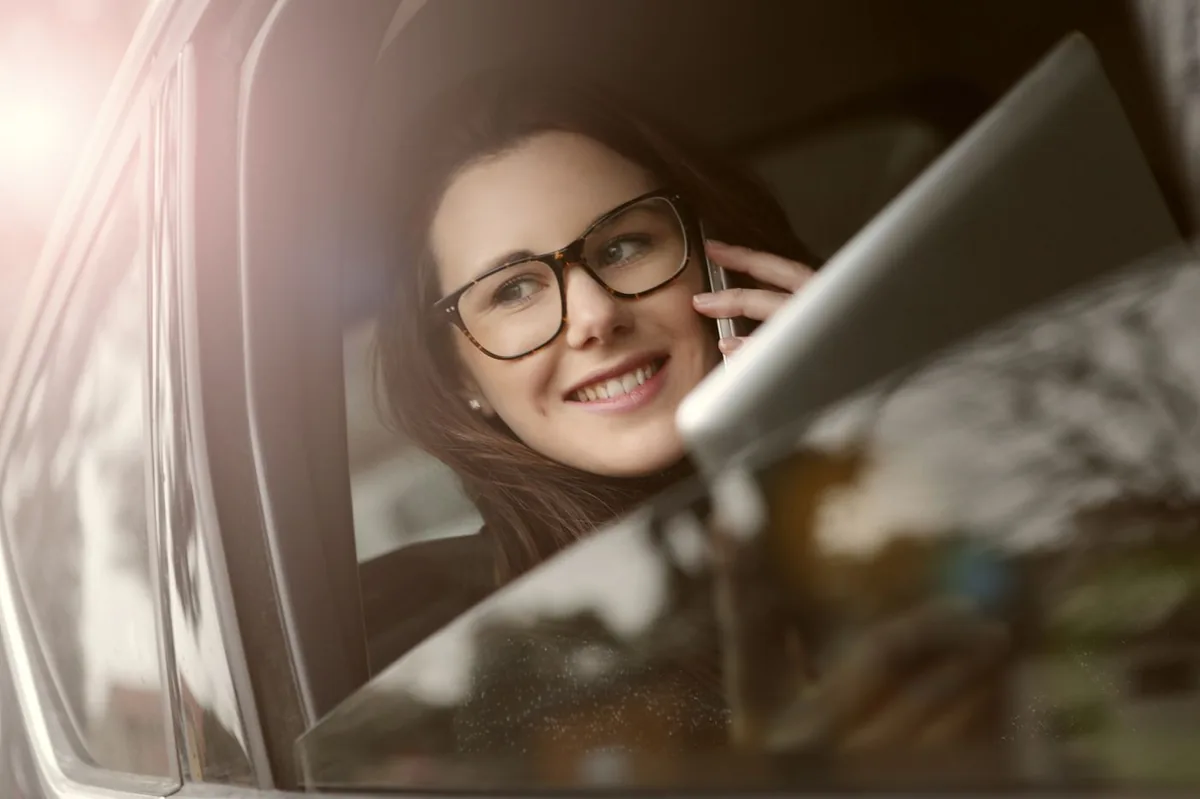 Driver on the phone in a car getting a Tennessee SR-22 insurance quote